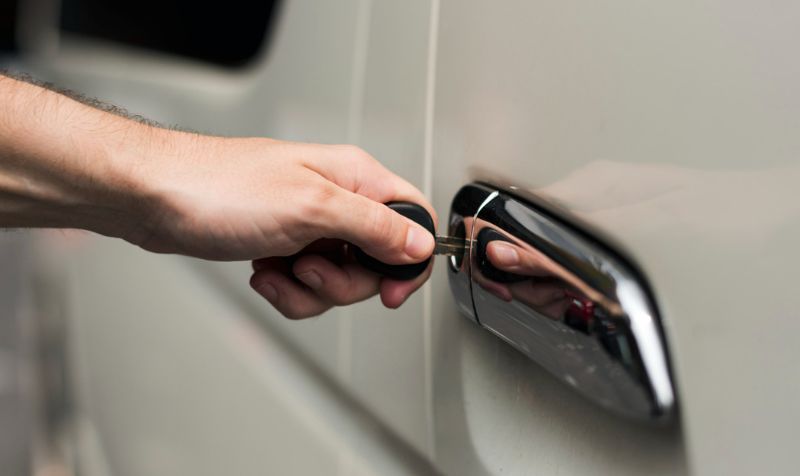 Power Window and Lock Repair image of the car door lock a male is opening the door