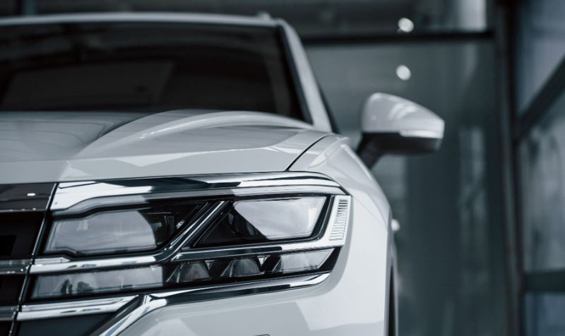 attention to details. particle view of modern luxury white car parked indoors at daytime attention to details. particle view of modern luxury white car parked indoors at daytime