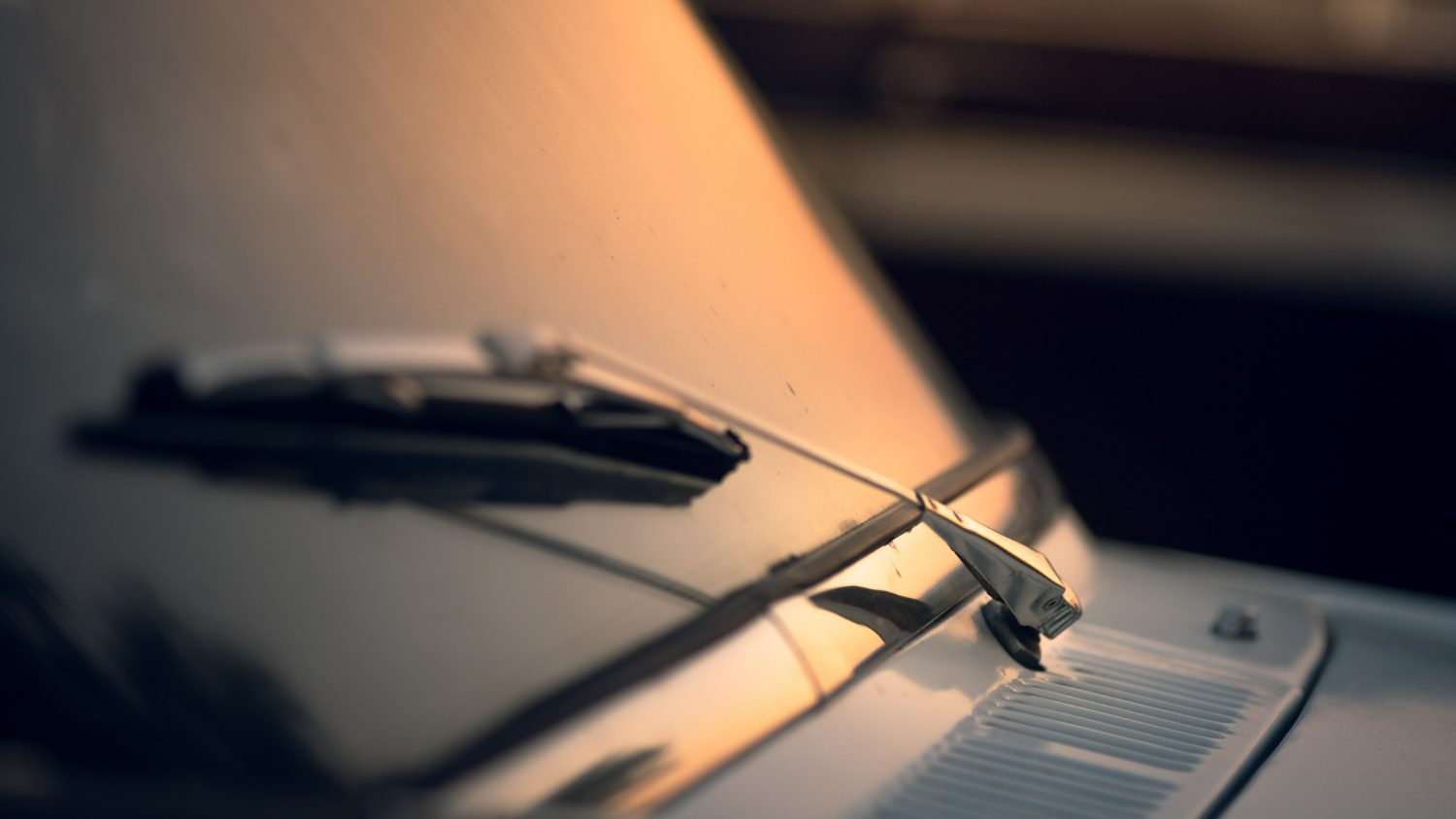 closeup shot of car wiper with a sunset background closeup shot of car wiper with a sunset background
